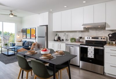 Open-concept kitchen and living area with balcony in an Abode rental home